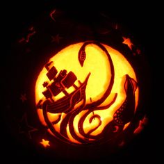 a carved pumpkin with an image of a ship on it's side and stars in the background