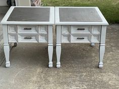 two white desks sitting on top of each other in front of a garage door