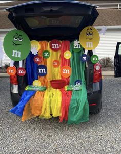 the trunk of a car decorated with different colored flags