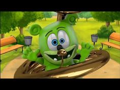 a green cartoon character sitting on top of a bench