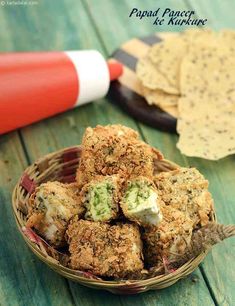 a basket filled with food next to crackers on top of a wooden table