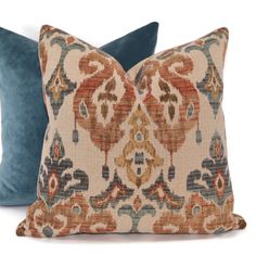 two pillows with blue and orange designs on them