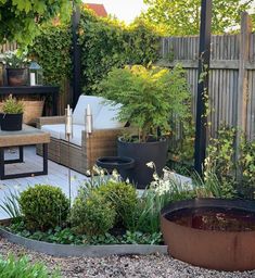 an outdoor patio with plants and seating area