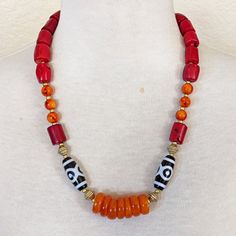 Materials: Red Coral Bamboo Barrel Beads, Burnt Orange Resin Rondelles, Orange And Red Swirl Glass Beads, Acrylic Black And White Ethnic Print Accent Beads, African Brass Bicones, Small Gold Glass Spacers, Gold Plated Lobster Clasp. Length: Approximately 23" And 2" Extender Chain Statement Necklace Boho Necklace Rustic Necklace Southwestern Style Necklaces With Large Beads, Artisan Red Beaded Necklace With Round Beads, Artisan Red Beaded Necklace, Bohemian Orange Single Strand Beads, Artisan Red Necklaces With Colorful Beads, Artisan Red Necklace With Colorful Beads, Red Bohemian Large Beads, Artisan Red Beaded Necklaces With Polished Beads, Southwestern Red Necklace With Polished Beads