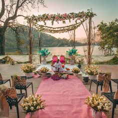 an outdoor ceremony setup with pink and white flowers