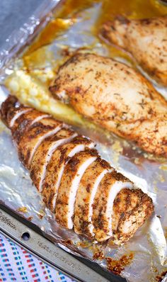 some chicken is sitting on top of tin foil and ready to be cooked in the oven