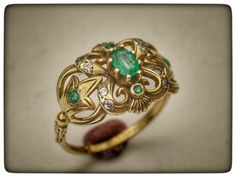 This stunning ring is my last and favorite design . 14k gold ring with emerald and diamonds . Central emerald stone weight : 0.6 carat . Diamond weight : 0.12 carat . Weight ring : 4.2 gram . Top ring length : 2 centimeter . Top ring width : 1.4 centimeter . Gold Emerald Ring With Diamond Accents, Heirloom Tsavorite Emerald Ring In Gold, Antique Emerald Ring With Prong Setting, Unique Yellow Gold Oval Emerald Ring, Unique Oval Emerald Ring In Yellow Gold, Handmade Elegant Diamond Ring, Exquisite Hallmarked Emerald Ring As A Gift, Unique Hallmarked Yellow Gold Emerald Ring, 14k Gold Emerald Ring With 17 Jewels - Collectible