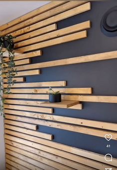 a wooden wall mounted to the side of a building with plants growing on top of it