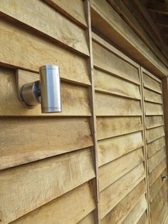 a close up of a wooden wall with a metal object on it's side