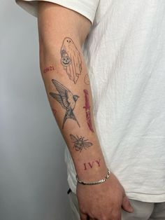 a man's arm with tattoos on it, including a bird and a hand