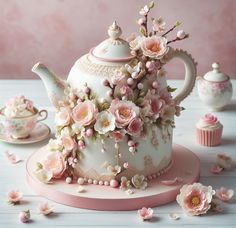 there is a tea pot with flowers on it