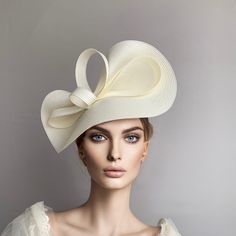 Elegant Cream Kentucky derby hat for woman. This ivory  fascinate hat is embellished with a big bow. It is a perfect hat for weddings, Royal Ascot horse races, Breeders cup, cocktails, derby... It is mounted on a headband. If you want, you can choose the side of the head were you like to wear the fascinator, just convo me. Any color of the fascinator can be changed to order.  * PROCESSING TIME: 5-7 business days. * DELIVERY TIME (DHL Express): 2-5 business days to all countries Kentucky Derby Church Fascinator, Elegant Fascinator For Royal Ascot Church, Elegant Fascinator For Church And Royal Ascot, Elegant Fascinator For Church At Royal Ascot, Wedding Hats With Bow And Short Brim, Elegant Boater Hat With Bow And Short Brim, Elegant Kentucky Derby Hat With Bow, Elegant Boater Hat For Royal Ascot And Church, Elegant Bow Hat For Kentucky Derby