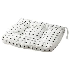 a black and white polka dot pillow on a white background