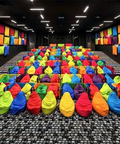 a room filled with lots of colorful bean bag chairs