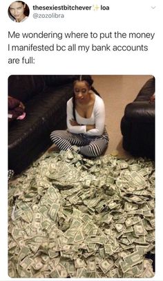 a woman sitting on the floor covered in money