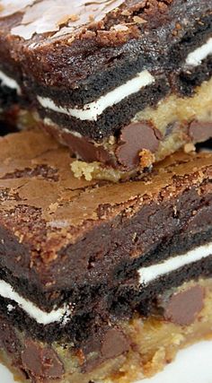 three chocolate brownies with marshmallows are stacked on top of each other