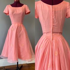 "Vintage 1950s coral pink cocktail party dress, with aaalllll the party in the back. A round neckline and waist in front, with piping detail and rose appliques. Soft floaty organza over a taffeta base. This dress boasts a GORGEOUS Basque waist with pleated detail in the back, with a dropped back neck. There is a metal Star zipper, and several hooks. Someone has sewn a stiff tulle crinoline into the dress by hand, and I have chosen to leave it as is. The crinoline hooks at the back, and gives great volume to the dress. The outer organza layer also has horse hair (a stiffening sewing strip, not animal product) onto the bottom hem for volume. Condition: excellent vintage condition. Some seam strain is seen on the back waist, but fairly minor. See last pic. Labels/tags:   Measurements: taken f 1950s Style Pink Vintage Dress For Party, 1950s Style Pink Vintage Party Dress, 1950s Style Pink Party Vintage Dress, Vintage Pink Dress With Fitted Bodice For Party, 1950s Pink Vintage Wedding Dress, Pink Vintage Dress With Fitted Bodice For Party, 1950s Style Pink Wedding Dress, Basque Waist Dress, Pink Cocktail Party