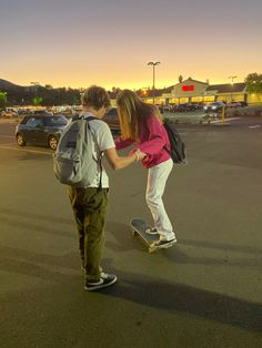 two people on skateboards in a parking lot