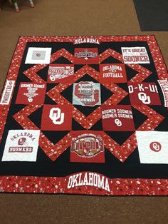 a quilted college blanket on the floor