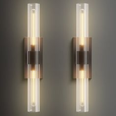 two lights that are next to each other on a wall mounted light fixture in a room