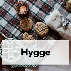 the words hygge are overlaid with cookies on a plaid table cloth