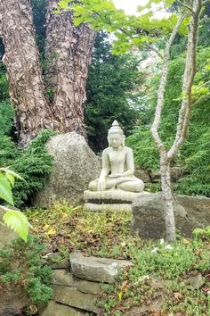 trees surround a white stone sitting statue Family Friendly Hotels, Peace And Quiet