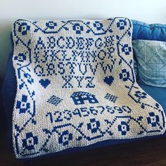 a crocheted afghan sits on a blue couch