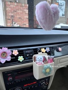 a car dashboard with some stuffed animals in it