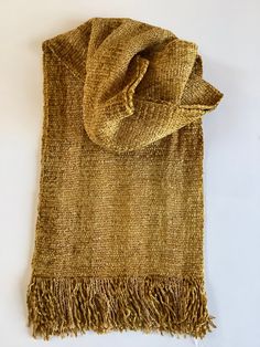 "Luxurious scarves handwoven in rich golds. The 100% rayon chenille fiber content provides rich colors, soft texture, and beautiful drape. Plus it is non-irritating to the skin. Both functional and fashionable. Hand wash, hang to dry, and steam iron. The gold scarf measures 9\" wide by 60\" long excluding fringe and the gold and yellow stripe is 7\" wide by 60\" long. The ends are secured with a tight zigzag machine stitch. I hand wash, dry, and iron all my scarves prior to shipping. Choose your Gold Shawl For Fall, Bohemian Gold Shawl Scarves, Gold Scarf, Handwoven Scarf, Steam Iron, Beautiful Drapes, Yellow Stripes, Rich Colors, Soft Texture