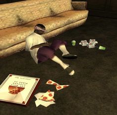 a person laying on the ground next to some pieces of paper and a pizza box