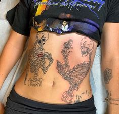 a woman with skeleton tattoos on her stomach