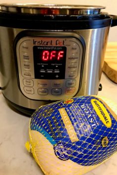 an instant pot roaster with the lid open next to a bag of rice and a digital pressure cooker