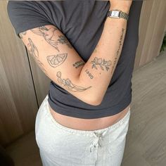 a woman with tattoos on her arms and armbands is taking a selfie