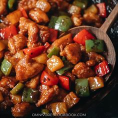 a wooden spoon full of chicken and peppers in a skillet with text overlay