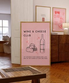 a wine and cheese poster is on the floor next to a table with a bottle