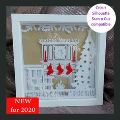 a white christmas card with red candles and stockings on the fireplace in front of it