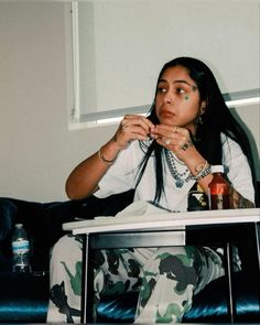 a woman sitting on top of a blue couch