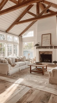 a living room filled with furniture and a fire place in the middle of an open floor plan