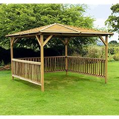 a wooden gazebo sitting on top of a lush green field