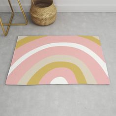 a rug with a rainbow design on the floor next to a basket and stools