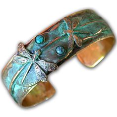 PRICES MAY VARY. Verdigris Patina Cuff Bracelet with Turquoise The dragonfly is the ultimate symbol of hope All items come on designer lavender merchandise cards with complete descriptions of the items. Hand crafted, executed by the artisan group at Elaine Coyne Galleries in Atlanta One-Of-A-Kind Coloration Verdigris Patina Solid Brass All our Patinas are created with heat and torches, using secret additives making every jewelry piece completely unique. This creates a one of a kind artistry that Turquoise Clothing, Feather Cuff Bracelet, Feather Cuff, Hammered Cuff Bracelet, Dragonfly Bracelet, Women Bracelets, Dragonfly Jewelry, Genuine Turquoise, Semi Precious Stones