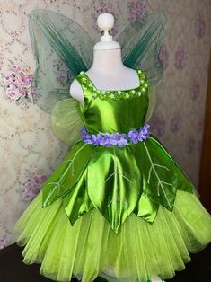 a green fairy dress with purple flowers on it