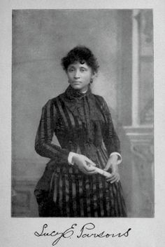 an old black and white photo of a woman in striped dress with her hands on her hips