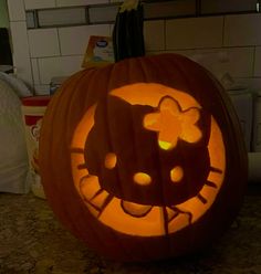 a pumpkin carved to look like a hello kitty face