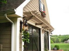 an outside view of a house with a large door and planter on the side