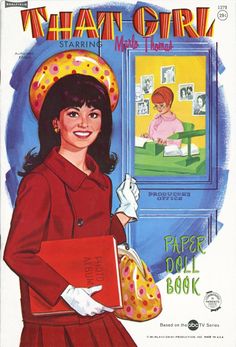 the cover of what's girl magazine featuring a woman in red holding a book