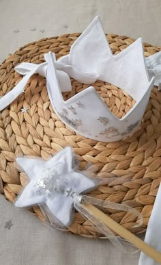 a basket with some white napkins on top of it and a wooden stick in the middle