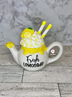 a ceramic teapot with lemonade on it