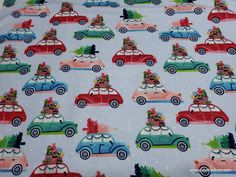 a blue fabric with cars and christmas trees on them