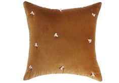 a brown pillow with small white butterflies on it's back and the bottom part of the pillow is made out of velvet